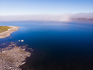 Fototapeta premium Clouds over lake water, Hardangervidda landscape, Norway
