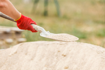 Person using shovel on construction site