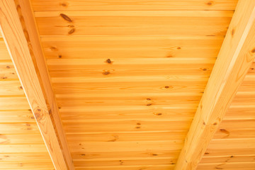 Construction of a wooden roof with wooden beams. Wood ceiling element