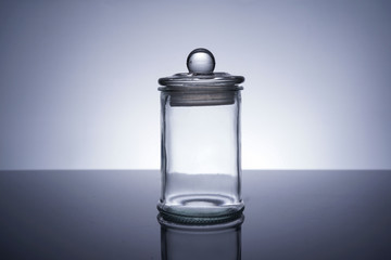 An empty glass container on white background
