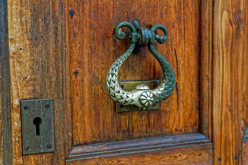 Close up of old wooden door handle in ortodox church