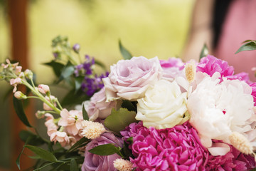 Beautiful wedding bouquet in bride's hands. Modern bouquet of different flowers.