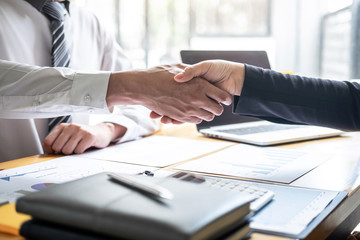 Finishing up a conversation after collaboration, handshake of two business people after contract agreement to become a partner, collaborative teamwork