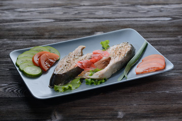 fish meat with vegetables and seasoning on a plate