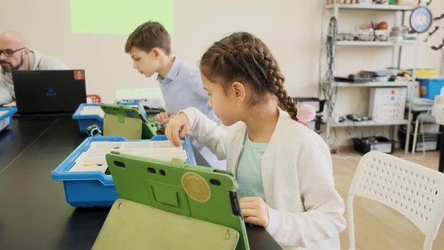 E-learning educational class for kids with smart boys and girls front view slow motion