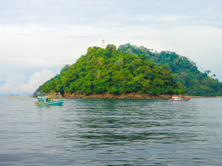 Fototapeta premium Fishermen Worked Out Are Job Using Long Tail Boats to Catch Fish in The Sea.