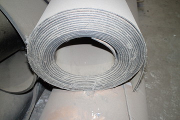 Conveyor belt coiled into roll