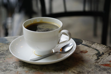 cup of black coffee on wooden table