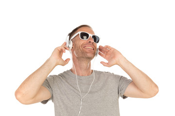 Handsome guy with sunglasses and headphones listening music