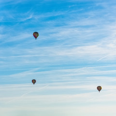 Three hot air balloons over French fields - Dinan, France
