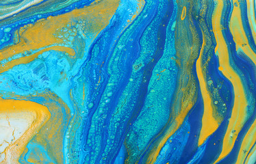 photography of abstract marbleized effect background. Blue, mint, yellow and white creative colors. Beautiful paint.