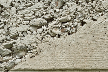 Concrete wall with gravel. Gray foundation of the house.