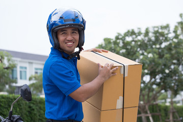 Delivery boy on scooter with parcel box driving fast in rush. Courier delivering express by motorcycle