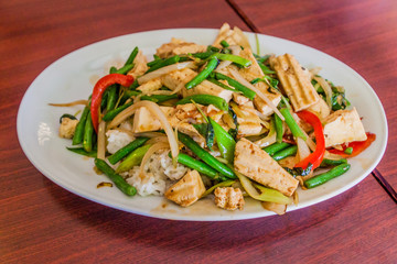 Plate of a Thai meal. Rice, tofu and vegetables.