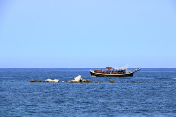 Excursion boat cruising Venetian harbour and mediterranean sea of Chania, Crete, Greece