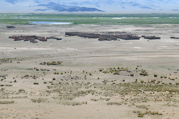 Western Mongolia steppe landscape. Old Kazakh cemetery in Khovd River valley. Outskirts of Tsengel...