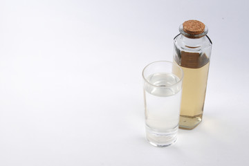 Clean water in glass and dirty water in bottle glass on white background