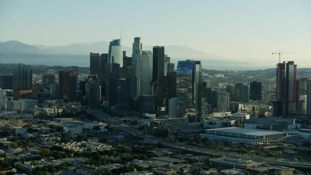 Aerial view LA skyscrapers with San Gabriel mountains