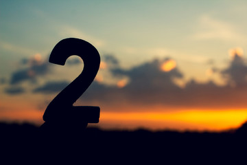 Number two sign symbol of wooden 2 text on evening nature sunset ,beautiful cloud