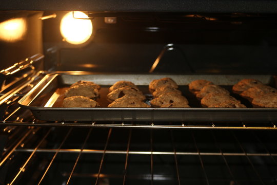 Fresh Chocolate Chip Cookies Being Baked In An Oven