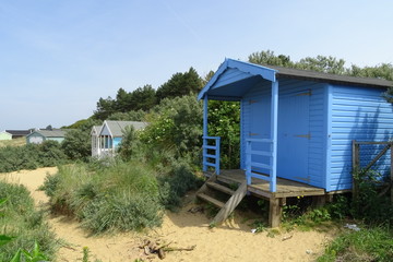 Obraz na płótnie Canvas Colourful beach huts on the beach at Hunstanton, Norfolk, England, UK