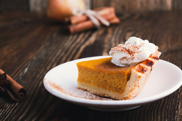 Slices of pumpkin pie with whipped cream, Thanksgiving day dessert
