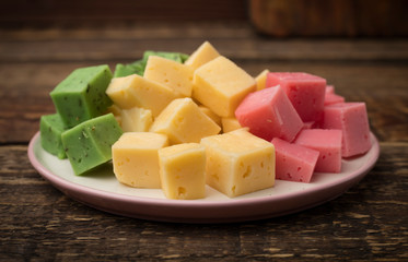 set of cheese on a plate. Wooden background. Copy space