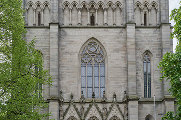 Fototapeta na wymiar Beautiful, high and pointed window in the Evangelical Church in Germany. Exterior of the evangelical church