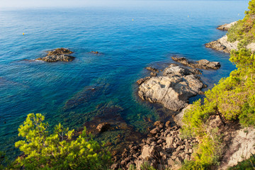 Fototapeta na wymiar Lloret de Mar sea coast. Costa brava rocky beach. Spanish coastline in mediterranean sea shore