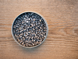 Pellets in a round box. Packing bullets on the Board.