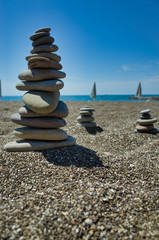 Stones pyramid on pebble beach symbolizing stability, zen, harmony, balance. Shallow depth of field. Black Sea
