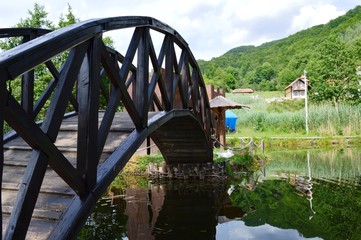 a small wooden bridge on the lake