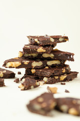 Homemade dark chocolate with walnut. Raw chocolate with nuts, kerob, stevia, acai, guarana. Selective focus, close up