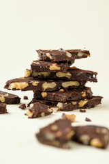 Homemade dark chocolate with walnut. Raw chocolate with nuts, kerob, stevia, acai, guarana. Selective focus, close up