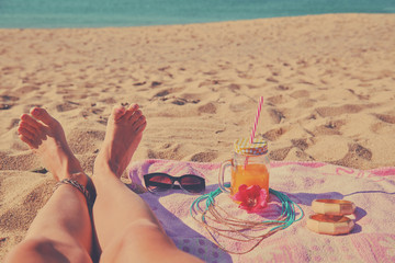 Woman lying down on the beach. Summer concept.