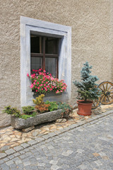 Fototapeta na wymiar Detail of traditional window decorated with flowers