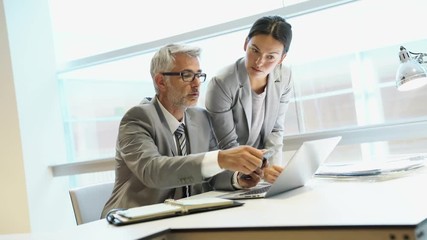 Corporate coworkers discussing business in office