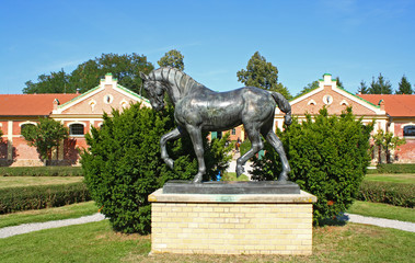 The horse statue at a stable of bricks.