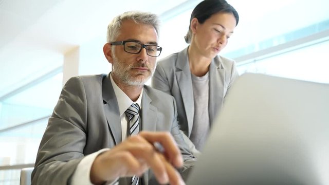 Corporate coworkers discussing business in office