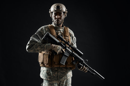 African Male Soldier Wearing Army Uniform Holding Weapon.