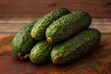 Fresh cucumbers on a wooden cutting board. Fresh harvest. Close up