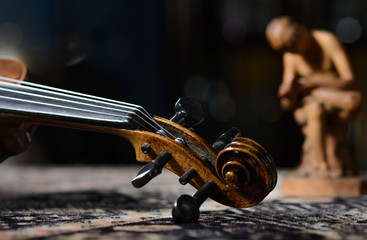 detail violin - still life with a wooden figure, due to the character contains grain / noise ratio...
