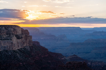 The setting sun sinking below the horizon of the Grand Canyon, near Yavapai point on the southern canyon rim.