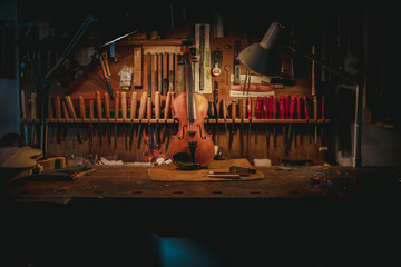 The finished violin standing on a wooden table