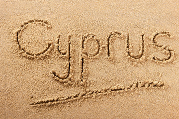Cyprus word written in sand on a sunny summer beach holiday vacation travel destination sign writing message photo