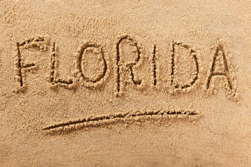 Florida word written in sand on a sunny summer beach holiday vacation travel destination sign...
