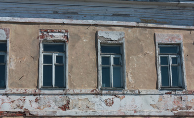 windows in the old wall with broken plaster