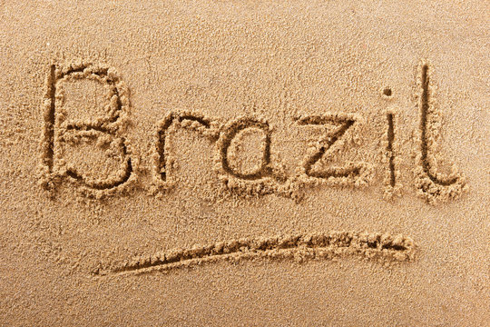 Brazil word written in sand on a sunny brazilian summer beach holiday vacation travel destination sign writing message photo