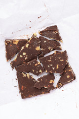 Homemade dark chocolate with walnut. Raw chocolate with nuts, kerob, stevia, acai, guarana. Selective focus, close up