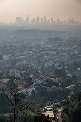 los angeles skyline and suburbs wrapped in smoke from woosle fires in 2018